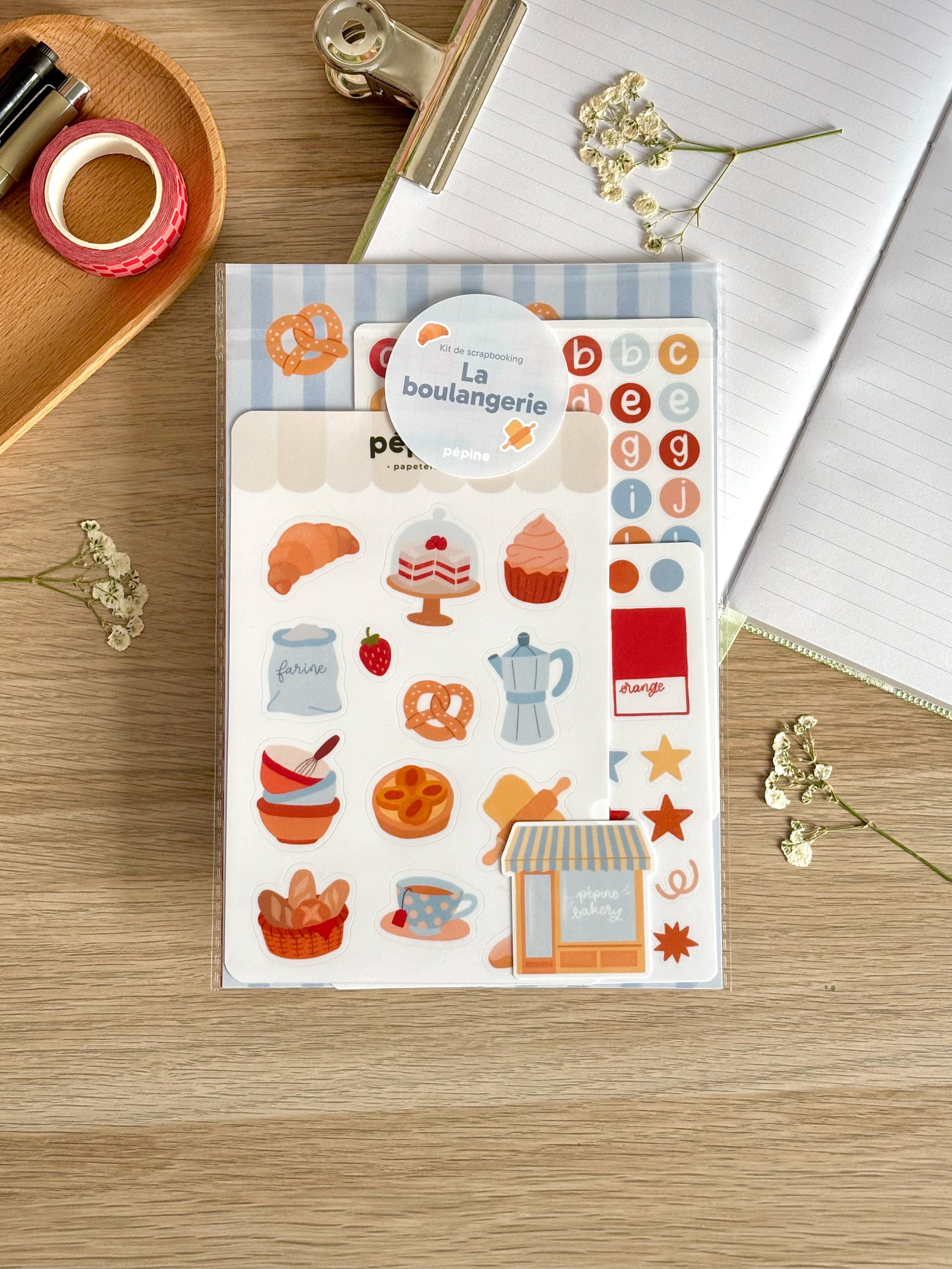 Le kit La boulangerie dans sa pochette, photographié sur un bureau en bois